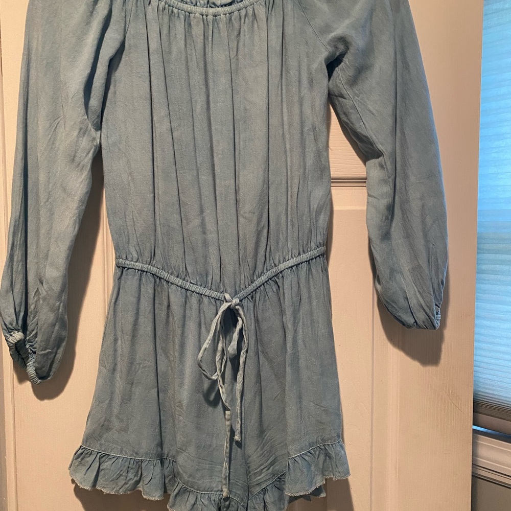 Cute denim romper with sleeves. Elastic waist with adjustable ties